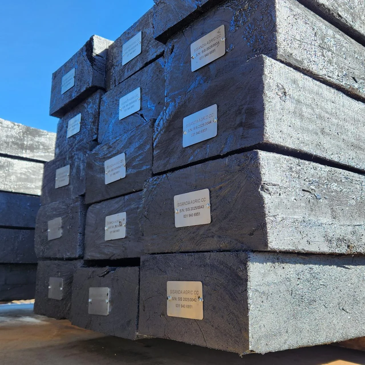 Treated sleepers with identification plates