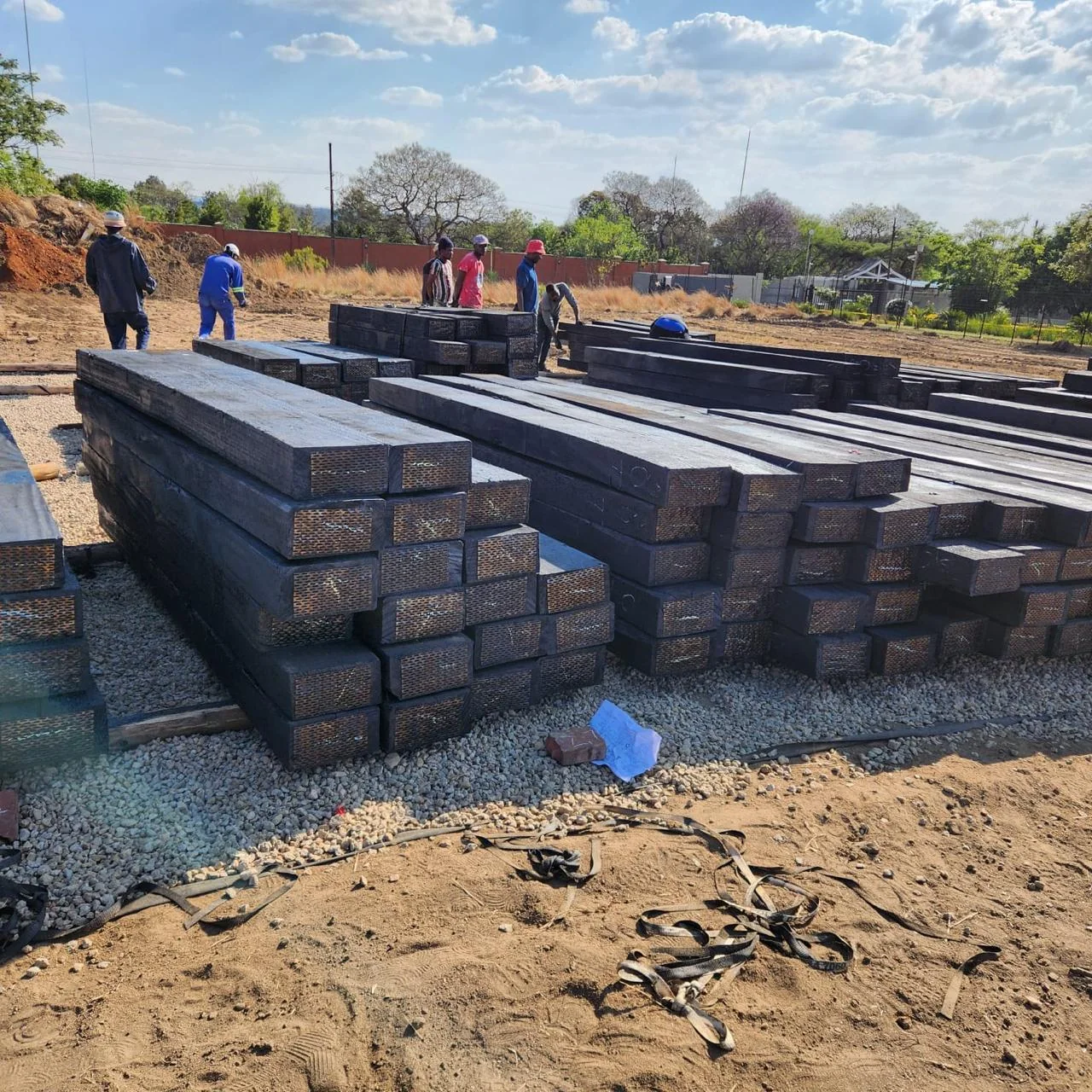 Treated hardwood sleepers stacked in a supply yard